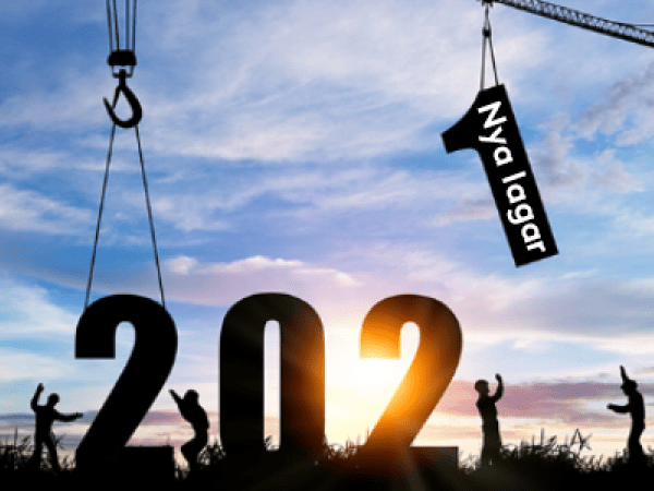 Lyftkranar och byggarbetare som placerar orden "Nya lagar 2021" på marken